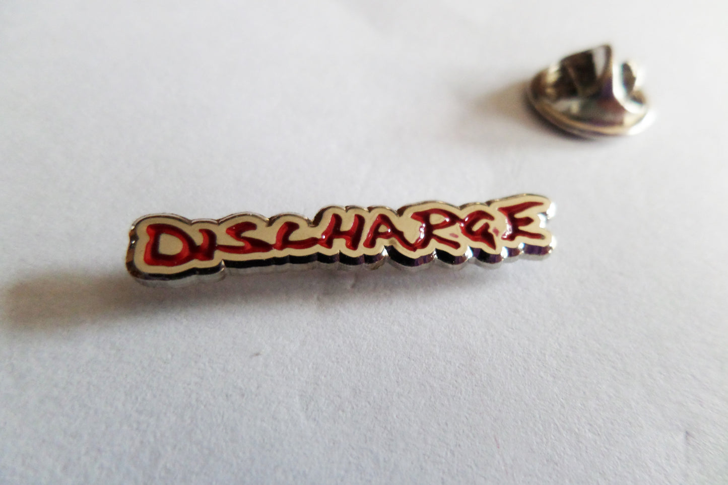 DISCHARGE logo punk metal badge (rare red version)