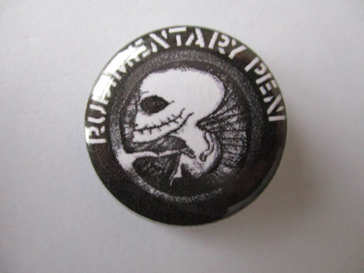 RUDIMENTARY PENI womb logo punk badge