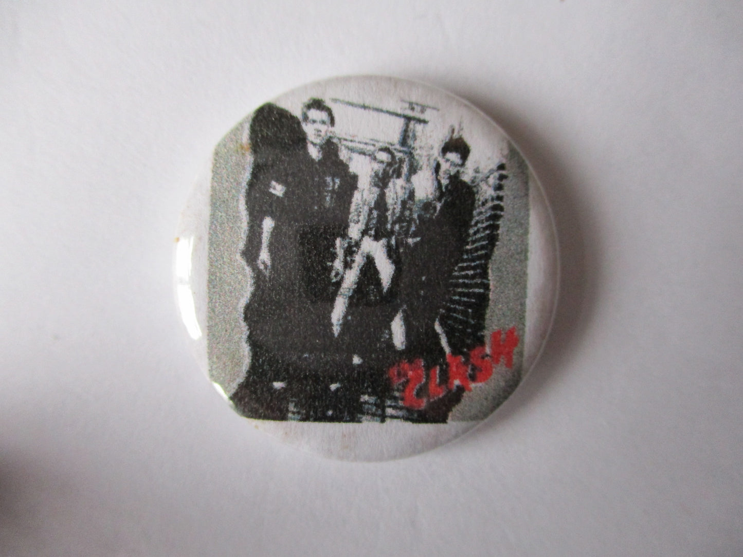 THE CLASH punk badge (VARIOUS OUT OF PRINT, discoloured)